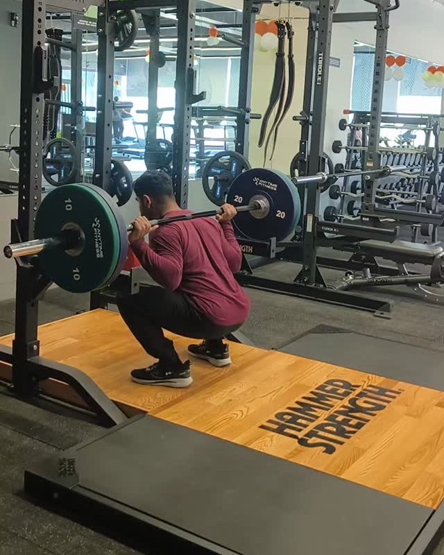 Deep barbell squat on a lifting platform